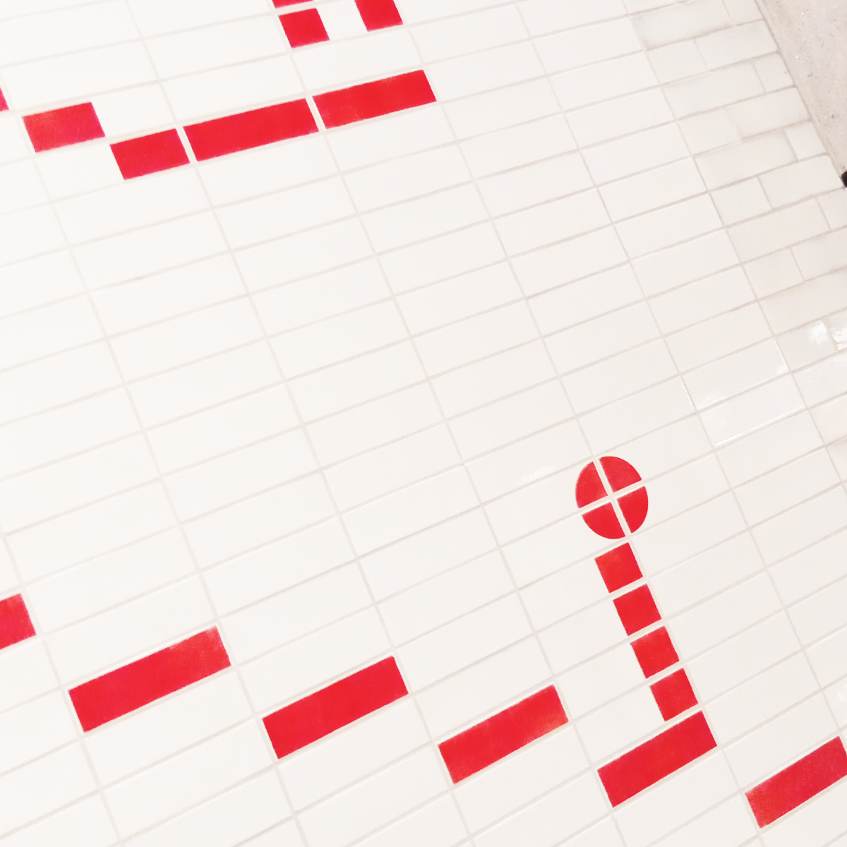 Metro wall detail  Geometric red and white tiled wall detail inside Weesperplein metro station in Amsterdam.